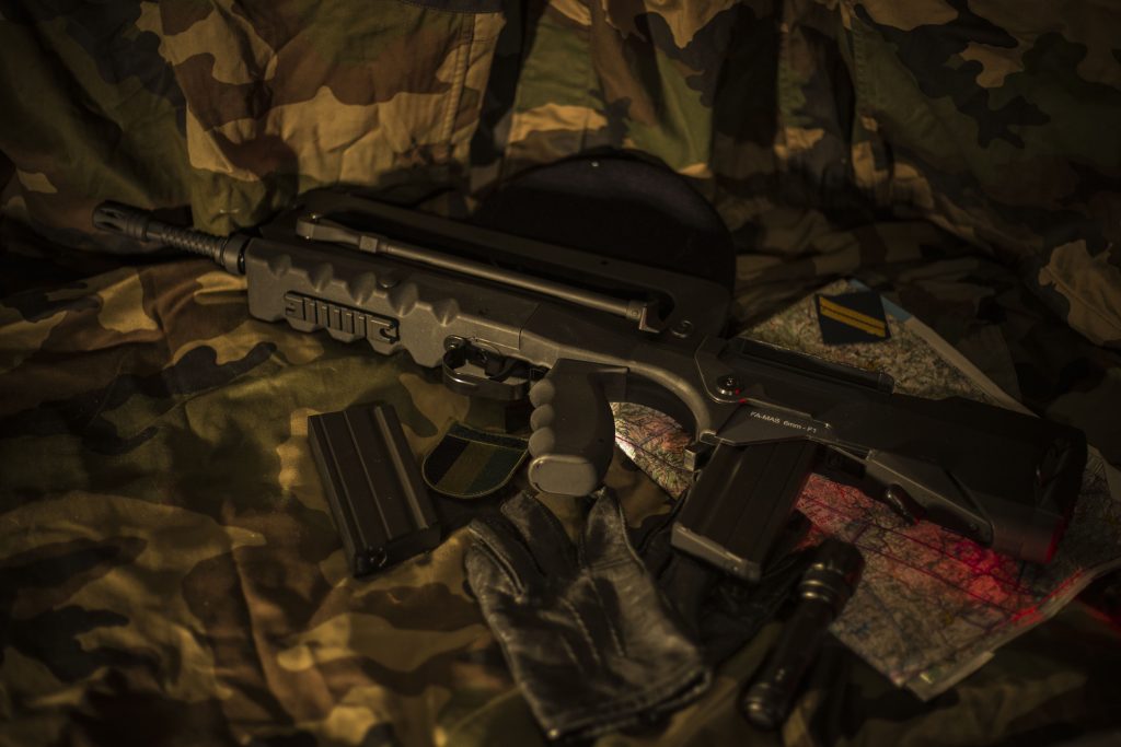 gun on camouflage cloth