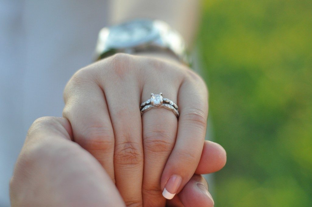 wearing an engagement ring