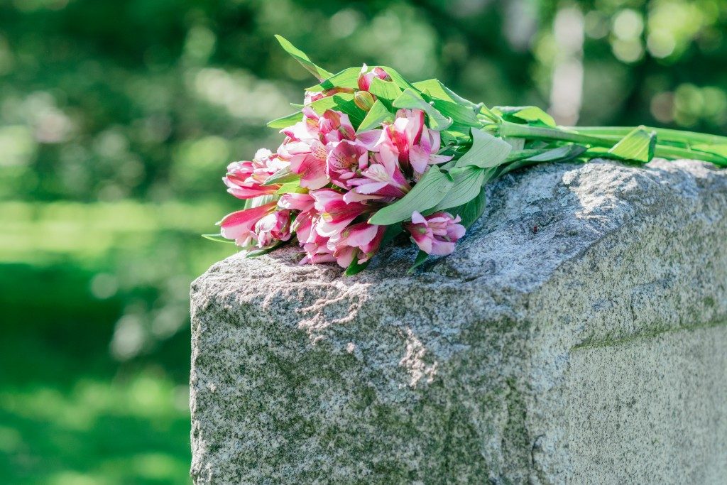flowers left on top of tombstone