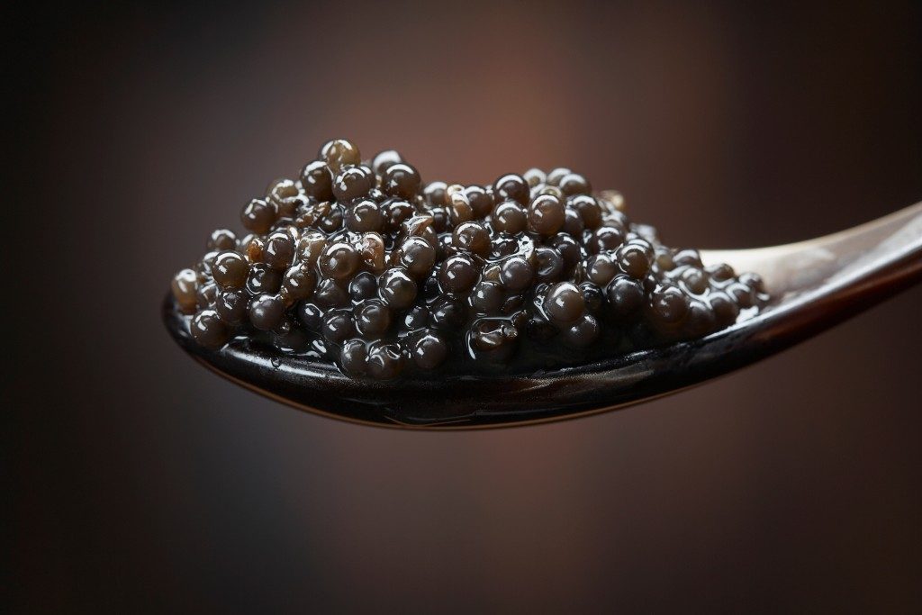 Black sturgeon caviar in silver spoon