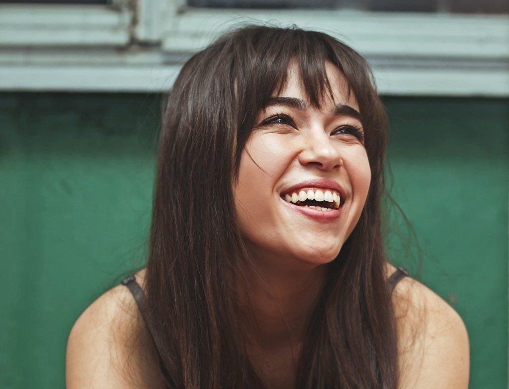 woman widely smiling