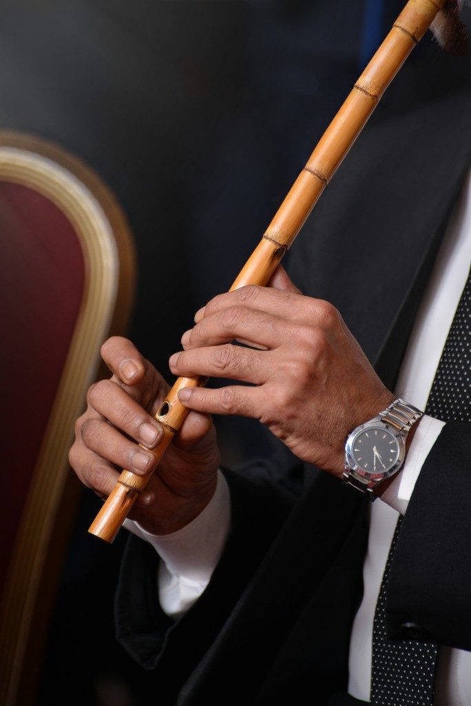 man using a bamboo flute
