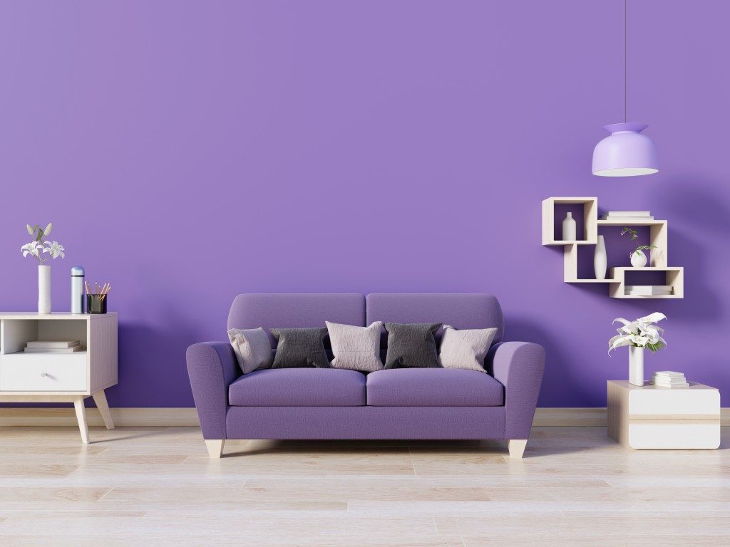 Purple couch near purple wall