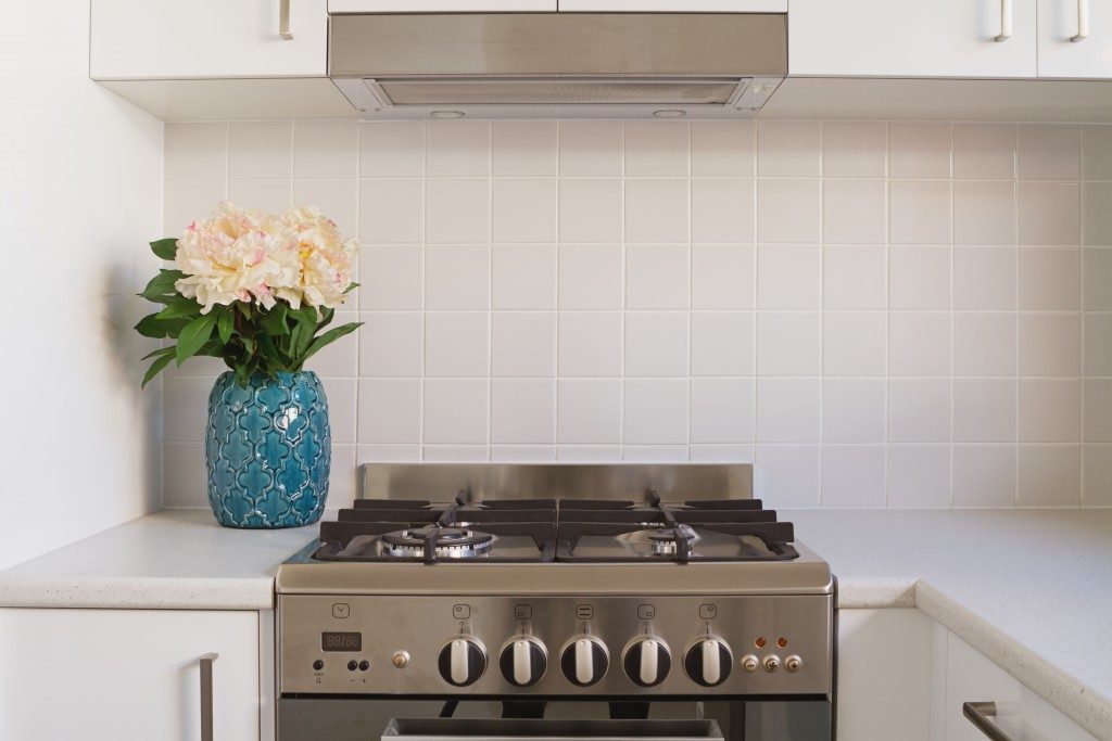 Close up of kitchen oven and tiled splashback in contempory apartmen