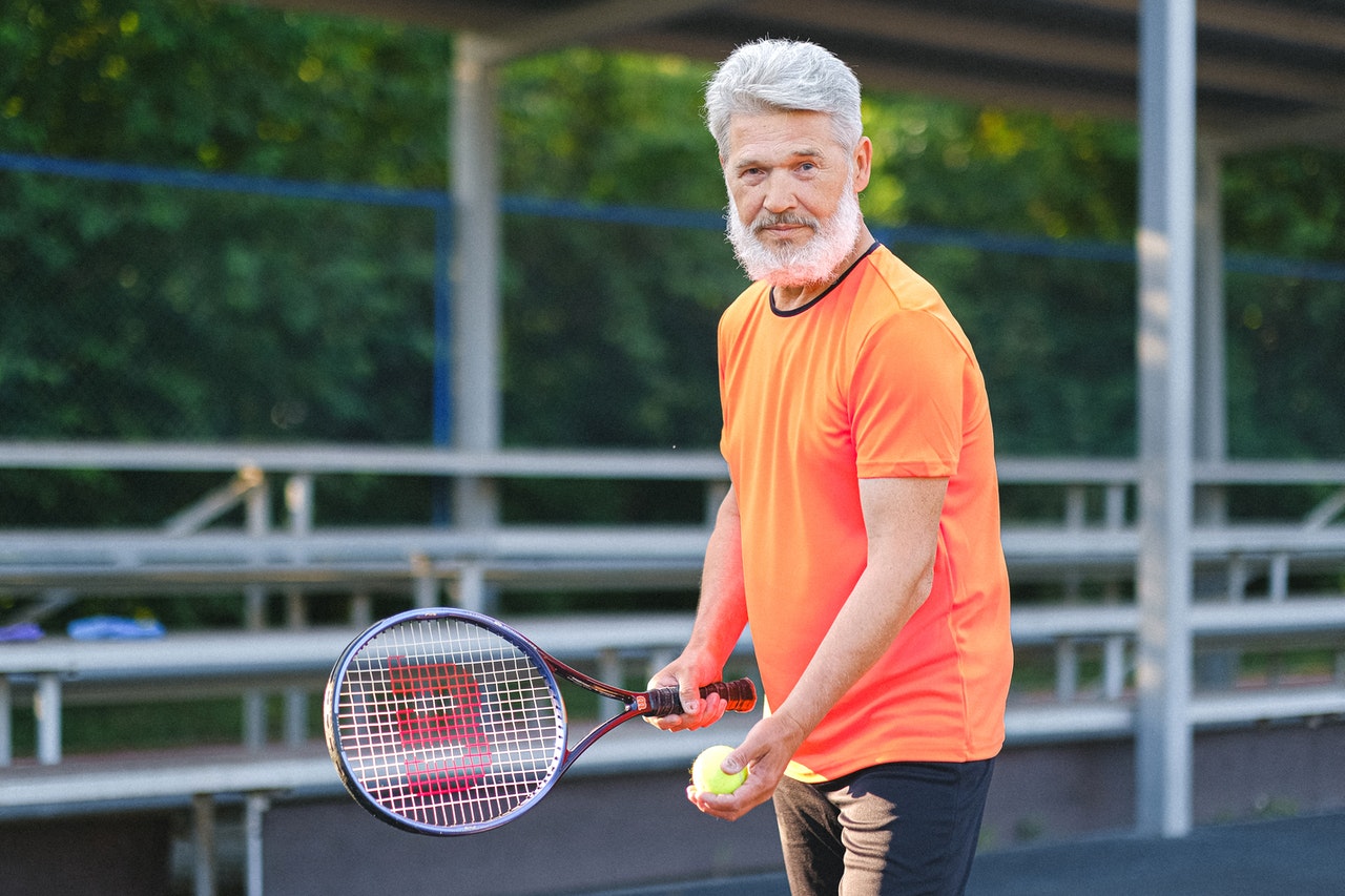 elder man playing tennis