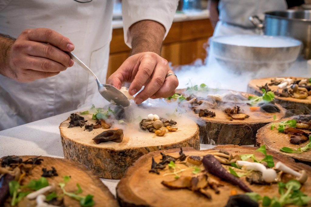 chef plating food with dry ice