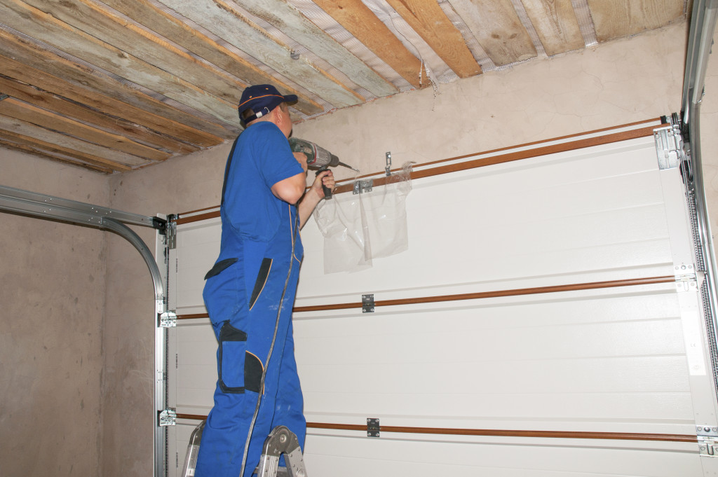 man bolting a frame for shelving in a garage