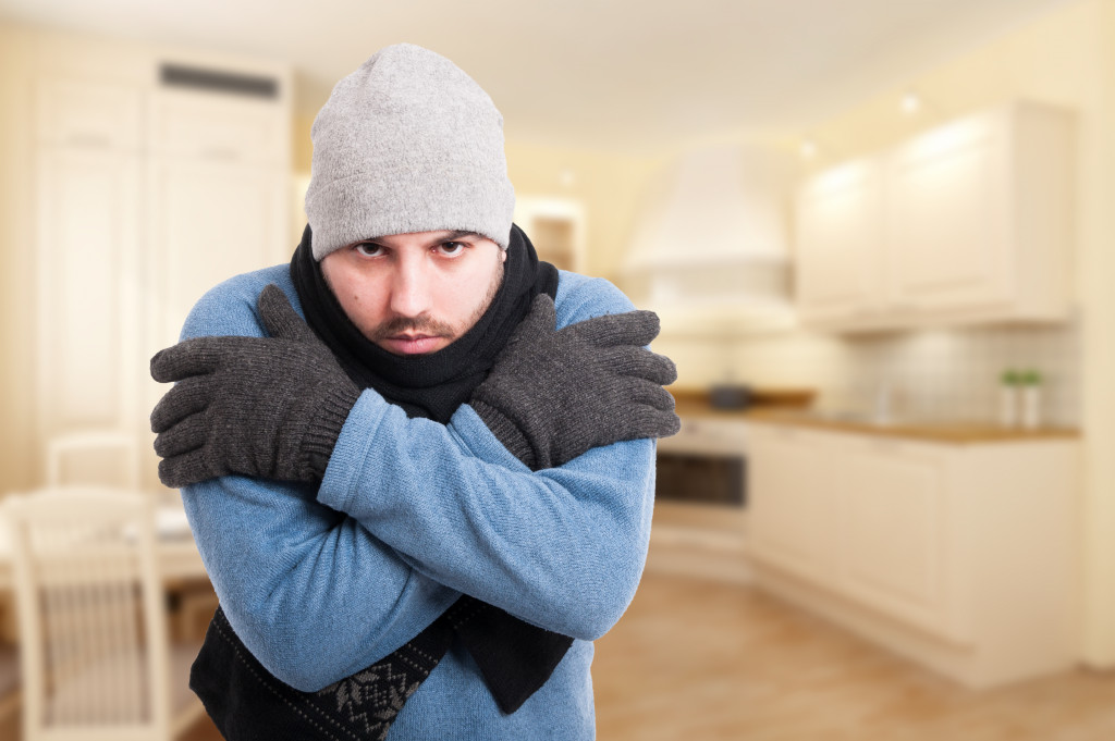 man covered in winter undergarments inside his house because of a fever