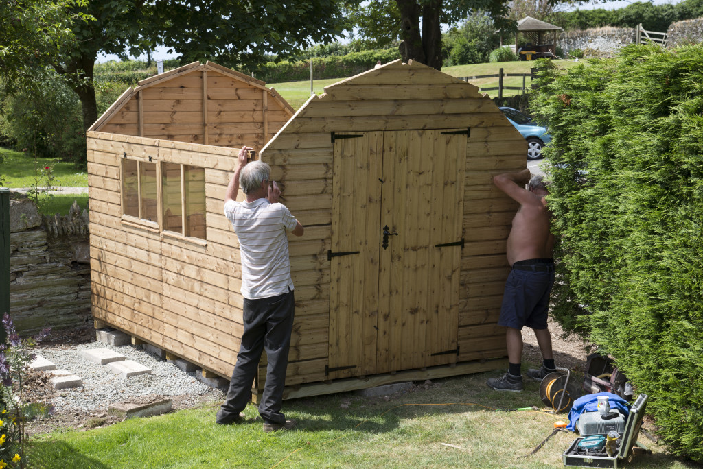 2 man creating a shed