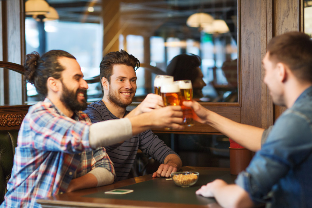Men toasting at a bar