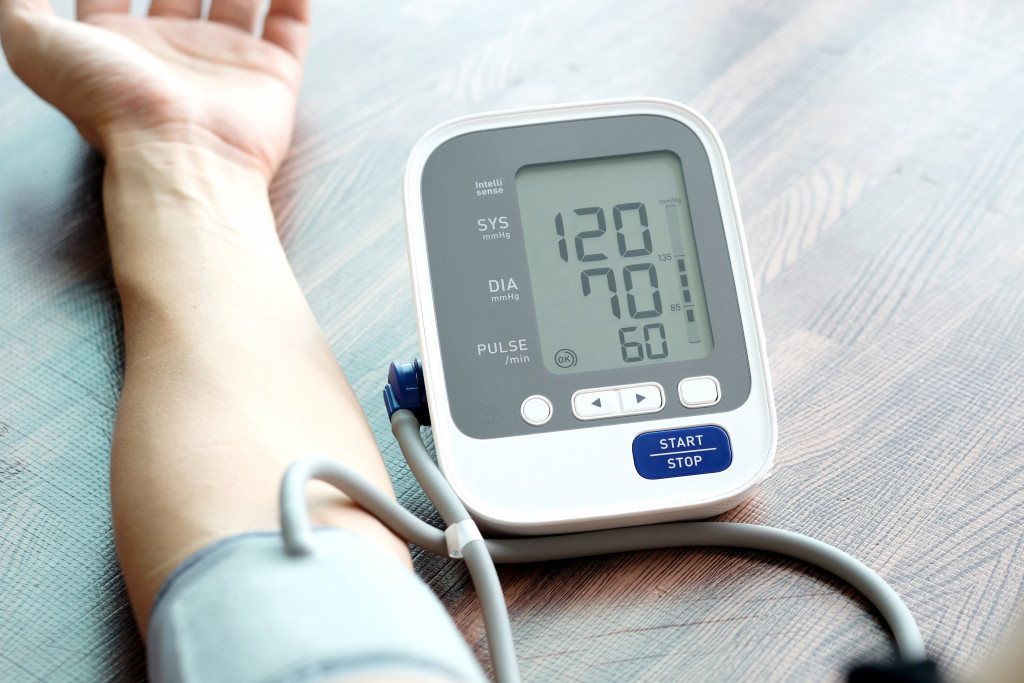 Man measuring his blood pressure at home