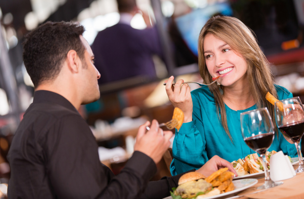 couple eating at a restaurant and looking happy