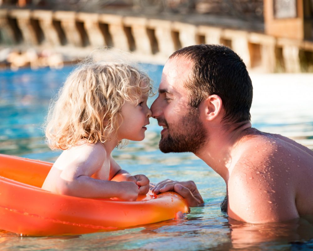 father and child in pool