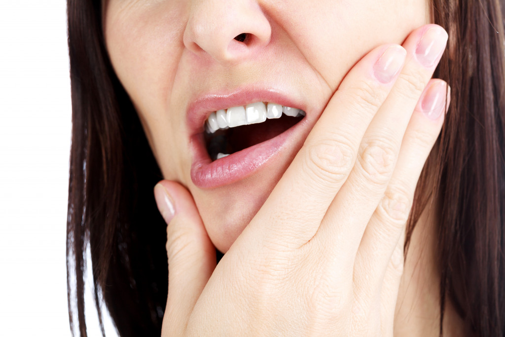 A woman experiencing extreme jaw pain